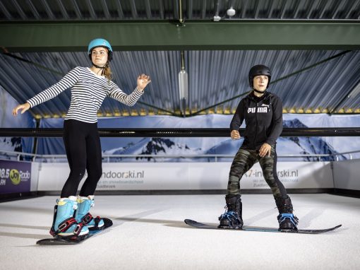 Snowboarders on a Indoor Ski Simulator